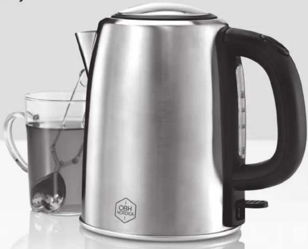 Modern stainless steel kettle with black handle and glass cup of water, no visible text or symbols on main subject