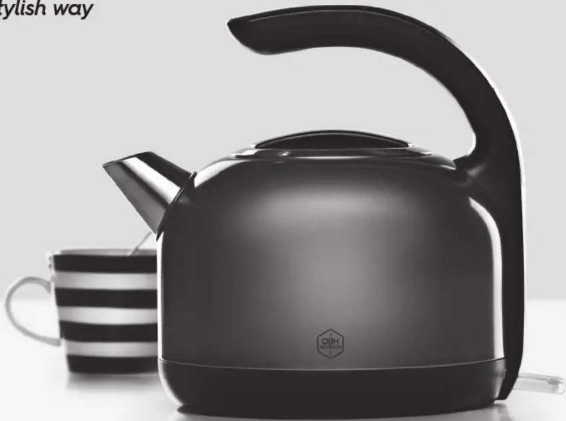 Black and white photo of a modern kettle with a striped mug beside it (no visible text or symbols)