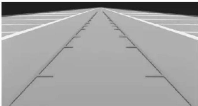 Aerial view of a long, straight road leading into the distance with parallel tracks (no text or symbols visible)