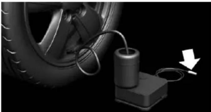 Close-up of a car tire connected to a battery and cable, with a white arrow indicating motion (no text or symbols)