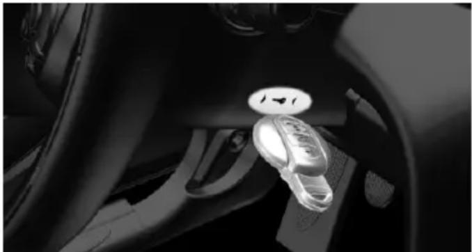 Close-up of a car interior showing the steering wheel and keyway (no visible text or symbols)