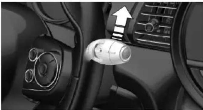 Interior view of a car dashboard with steering wheel and directional arrow indicator (no text or symbols)