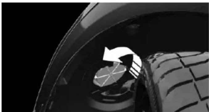 Close-up of a car wheel rim and tire, showing a circular arrow indicating rotation or direction (no text or symbols)