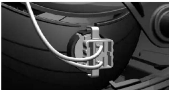 Close-up of a car tire mounted on a vehicle wheel, showing wiring and components (no visible text or symbols)