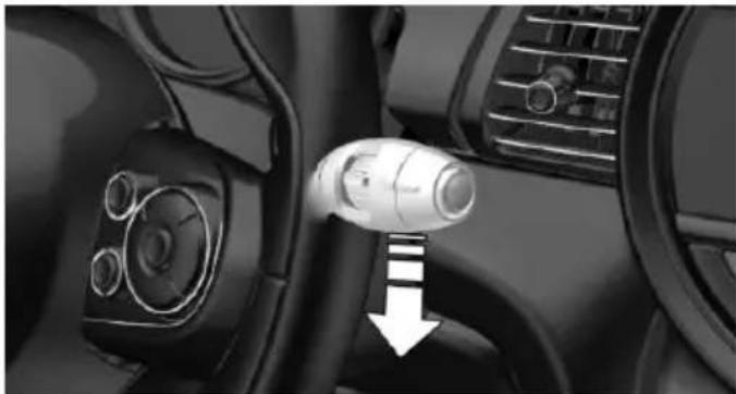 Interior view of a car dashboard with a white connector and directional arrow (no text or symbols visible)