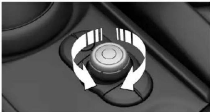Close-up of a mechanical knob with circular arrows indicating rotation or clockwise motion (no text or symbols)