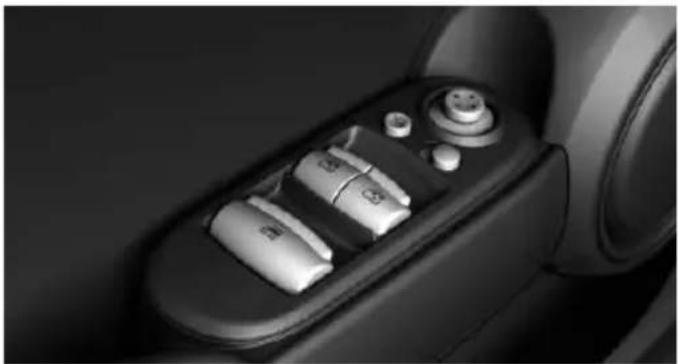 Close-up of a car's rearview control panel with buttons and dials (no visible text or symbols)