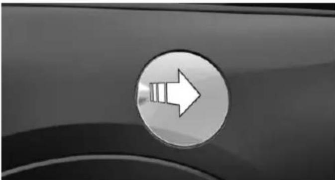 Close-up of a car's side panel showing a white right-pointing arrow on a circular button (no text or symbols)