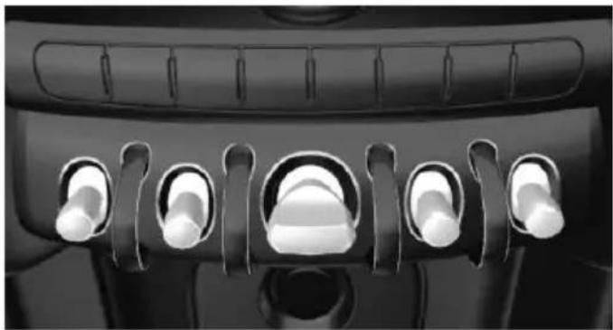 Close-up of a car dashboard with six white buttons arranged in a row (no text or symbols visible)