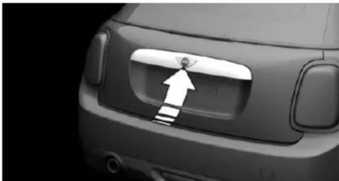 Close-up of a car's rear bumper with a white arrow pointing to the nose area (no text or symbols visible)