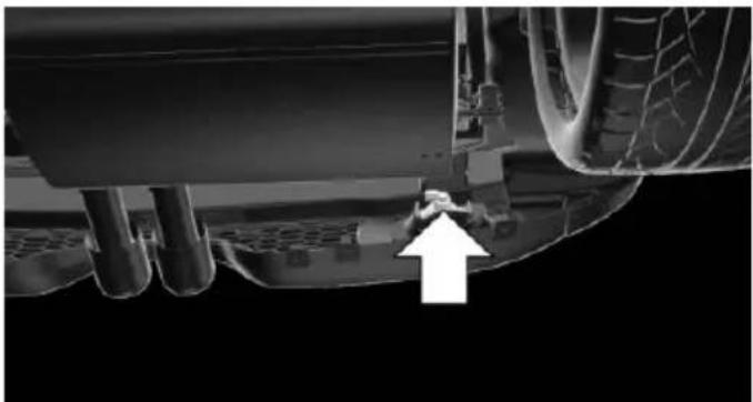 Close-up of a car's lower suspension system with an arrow pointing to the vehicle wheel (no text or symbols visible)