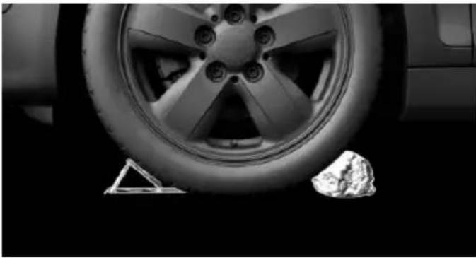 Close-up of a car wheel and tire on a stand, no visible text or symbols