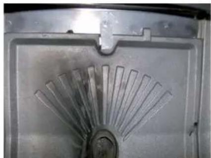 Close-up of a metallic mechanical component with radial slots, no visible text or symbols