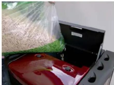Exterior view of a portable stove with red and black plates, green bags, and plastic wrap (no visible text or symbols)