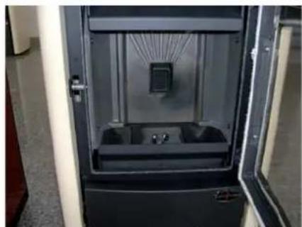 Interior view of a black and white industrial enclosure with a central display unit (no visible text or symbols)