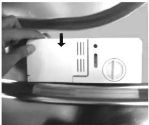 Hand holding a battery with a warning symbol and a coin, indicating battery hazard or inspection.