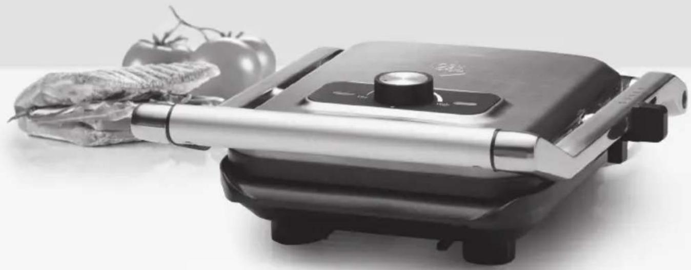 Black and white photo of a K-fried grater with a sandwich, tomato, and cheese nearby (no visible text or symbols)