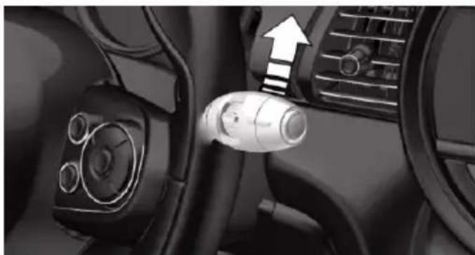 Interior view of a car dashboard with steering wheel and directional arrow indicator (no text or symbols)