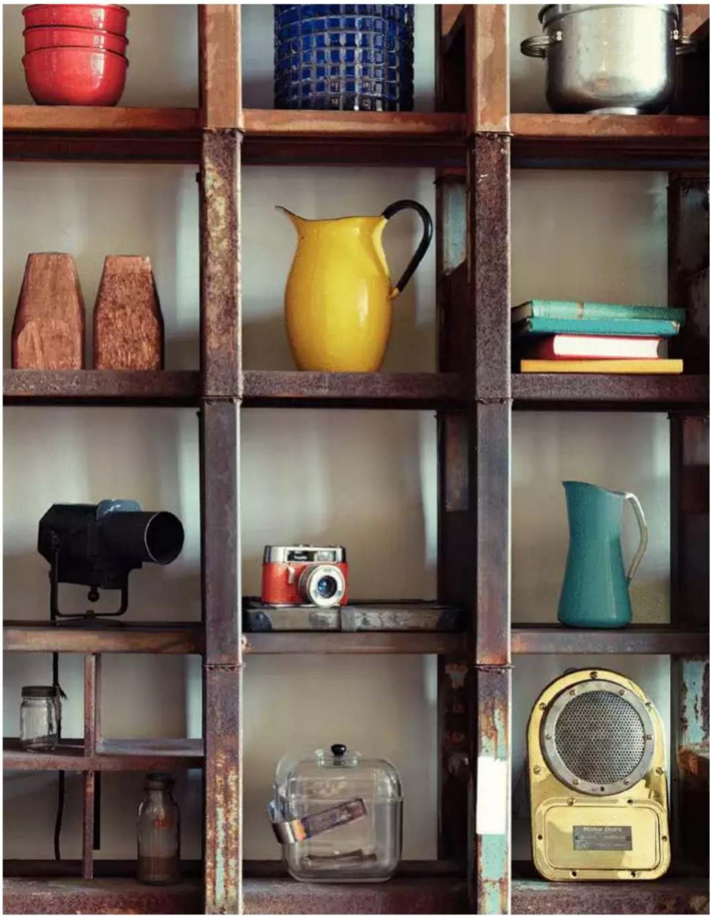 Interior view of a rustic metal shelving unit with various kitchenware and storage items (no visible text or labels)