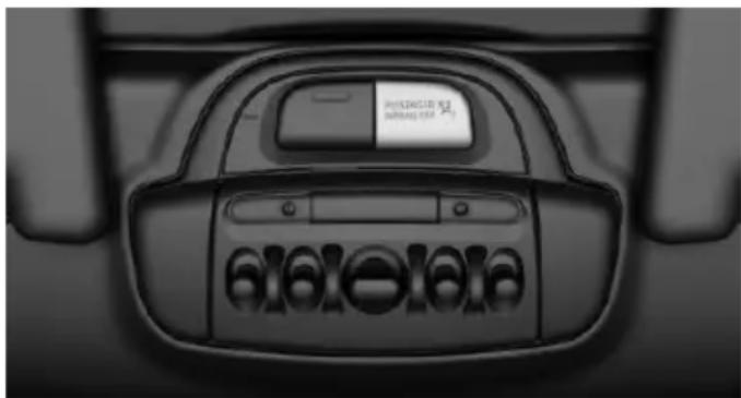 Top-down view of a car's front panel showing the dashboard and control buttons (no readable text or symbols)