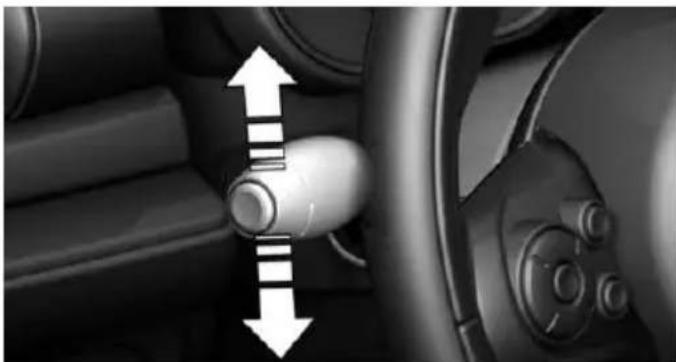 Interior view of a car showing a vehicle wheel and dashboard with directional arrows indicating movement (no text or symbols)