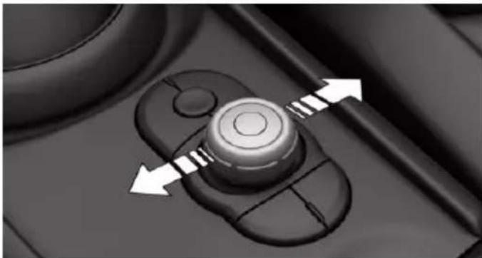 Close-up of a mechanical control knob with directional arrows indicating rotation or movement (no text or symbols)