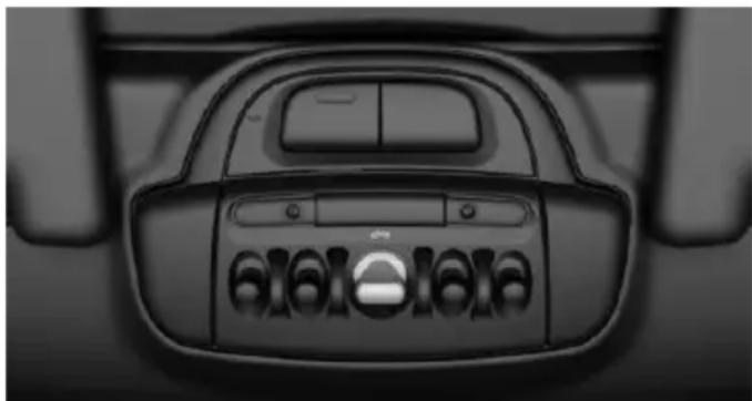 Top-down view of a car's front dashboard with visible buttons and grille (no text or symbols)
