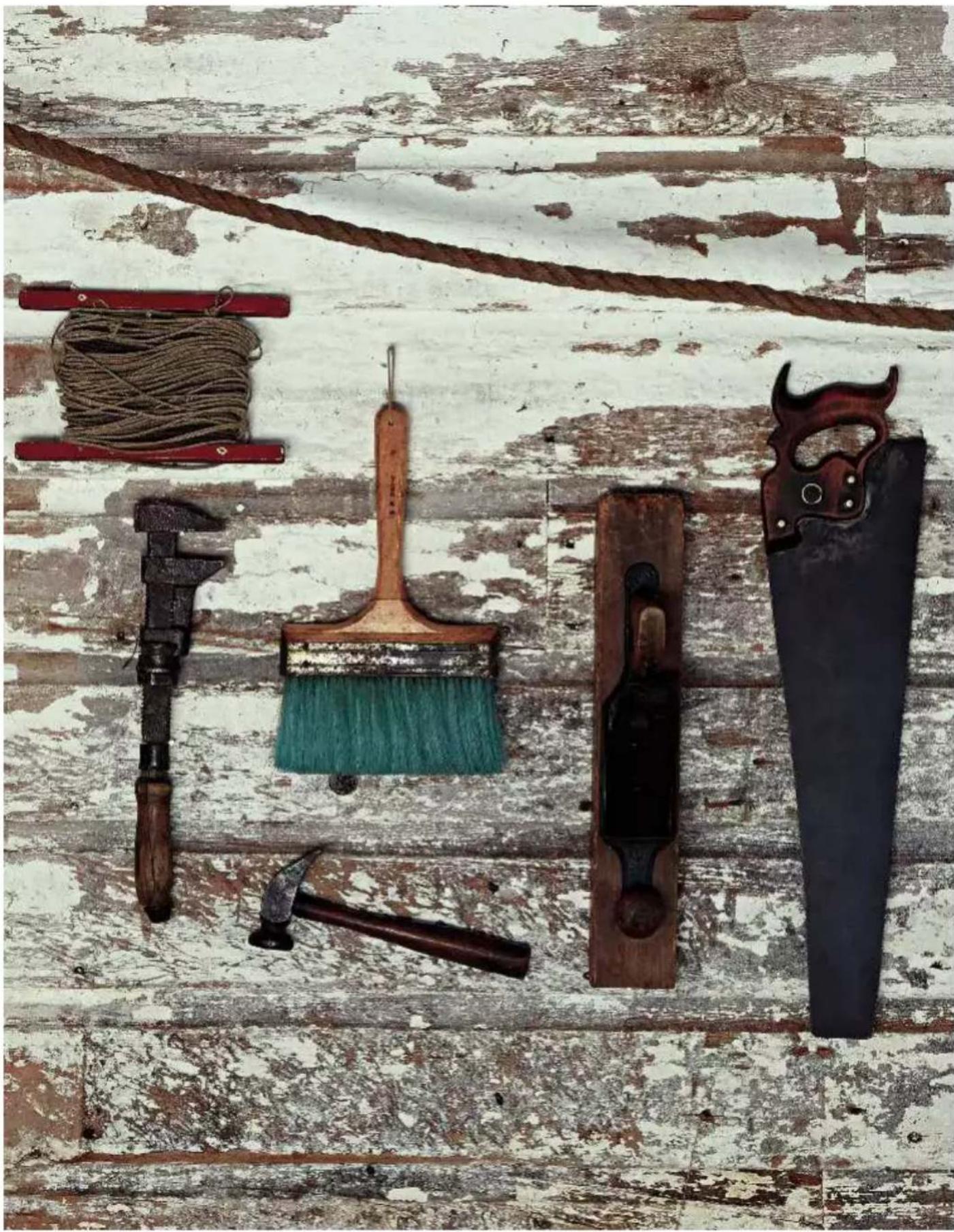 Still life arrangement of old hand tools including brooch, saw, and saw (no text or symbols visible)