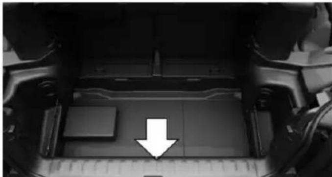 Top-down view of a vehicle chassis with a white arrow pointing to a component on the back (no text or symbols visible)