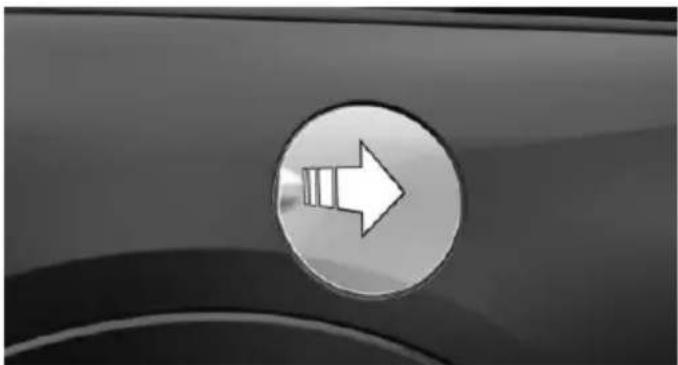 Close-up of a car's side panel showing a white right-pointing arrow on a circular button (no text or symbols)