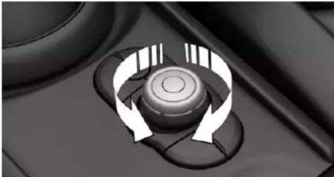 Close-up of a mechanical knob with circular arrows indicating rotation or cycle (no text or symbols)