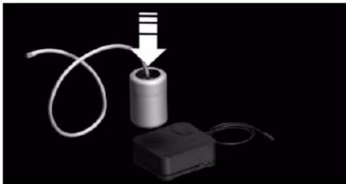 3D illustration of a battery connected to a cable with a plug, against a black background (no text or symbols)