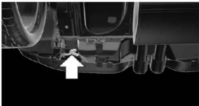 Undercarriage view of a vehicle showing structural components and a white arrow pointing to a specific part (no text or symbols present)