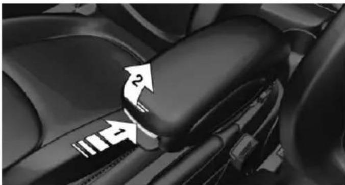 Close-up of a car's rear seatbelt mechanism with directional arrows indicating motion (no text or symbols)