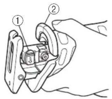 Technical diagram showing a hand holding a mechanical clamp or bracket with labeled parts ① and ②