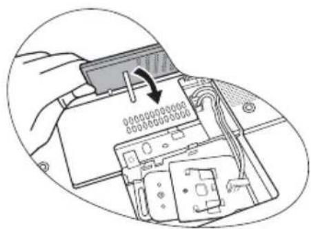 Diagram showing a hand inserting a component into an electronic device with labeled pins and cable routing