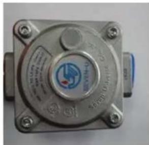 Close-up of a metallic industrial control unit with visible branding and text labels