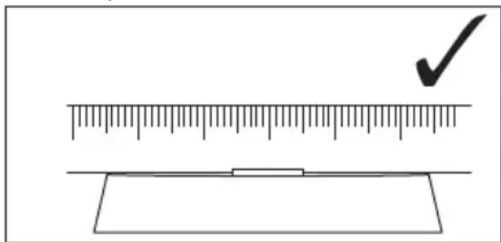 Diagram showing a ruler measuring a rectangular object with a checkmark indicating the measurement.