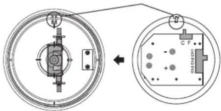 Technical diagram showing a circular component with internal components and an inset view of a device labeled 'C F' with part number 10-100.