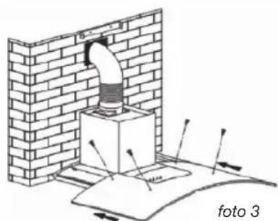 Diagram of a chimney mounting a brick wall, with arrows indicating direction and no readable text or symbols