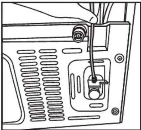 Line drawing of a computer monitor rear panel with a cable inserted, showing internal components and ventilation slots (no text or symbols).