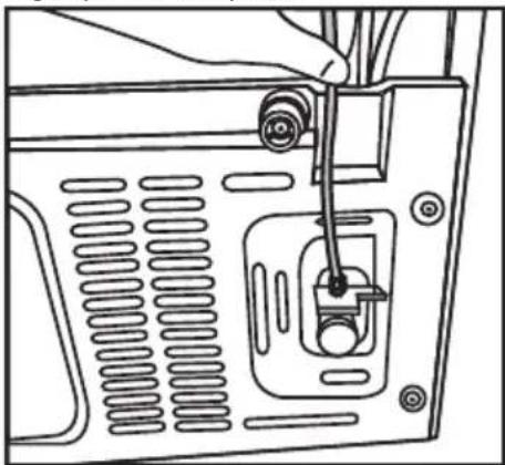 Line drawing of a computer monitor rear panel with a cable inserted, showing internal components and ventilation slots (no text or symbols)