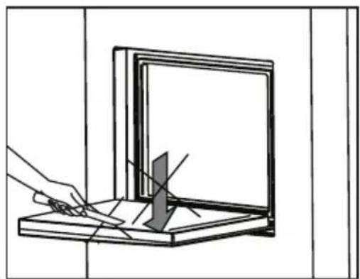 Line drawing of a hand using a tool to cut or mark a rectangular object on a wooden base (no text or symbols).