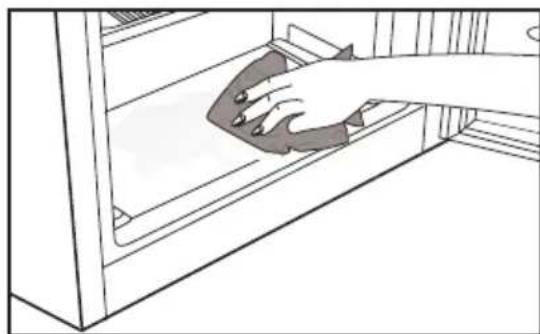 Line drawing of a hand cleaning a cabinet interior (no text or symbols)