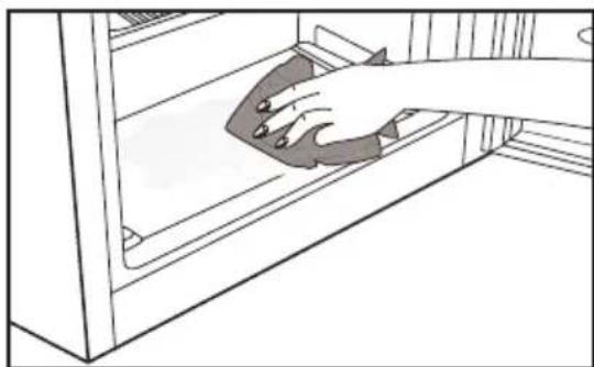 Line drawing of a hand cleaning a shelf with a cloth (no text or symbols).