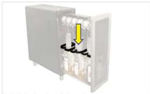 Interior view of an open electrical cabinet with visible wiring and a yellow arrow pointing to the interior (no text or symbols)