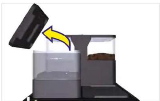 Illustration of a coffee machine with a yellow arrow indicating compression or lifting process (no text or symbols)