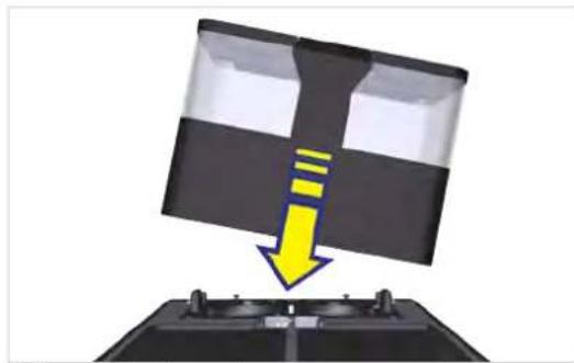 Diagram showing a device with a yellow arrow pointing downward to a black panel, mounted on a base, no text or symbols present.