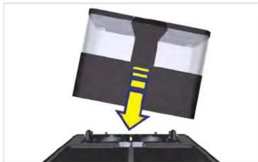 Diagram showing a device with a yellow arrow pointing downward to a black panel, mounted on a base (no text or symbols present).