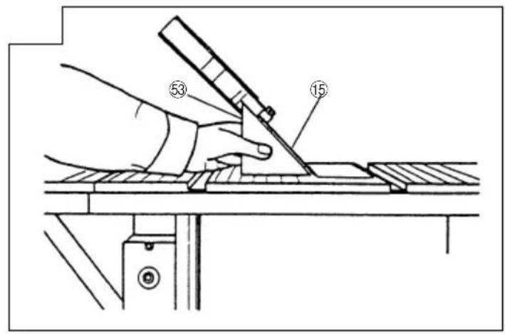 Technical diagram showing a hand using a tool to cut or mark a surface, with labeled parts 53 and 15.
